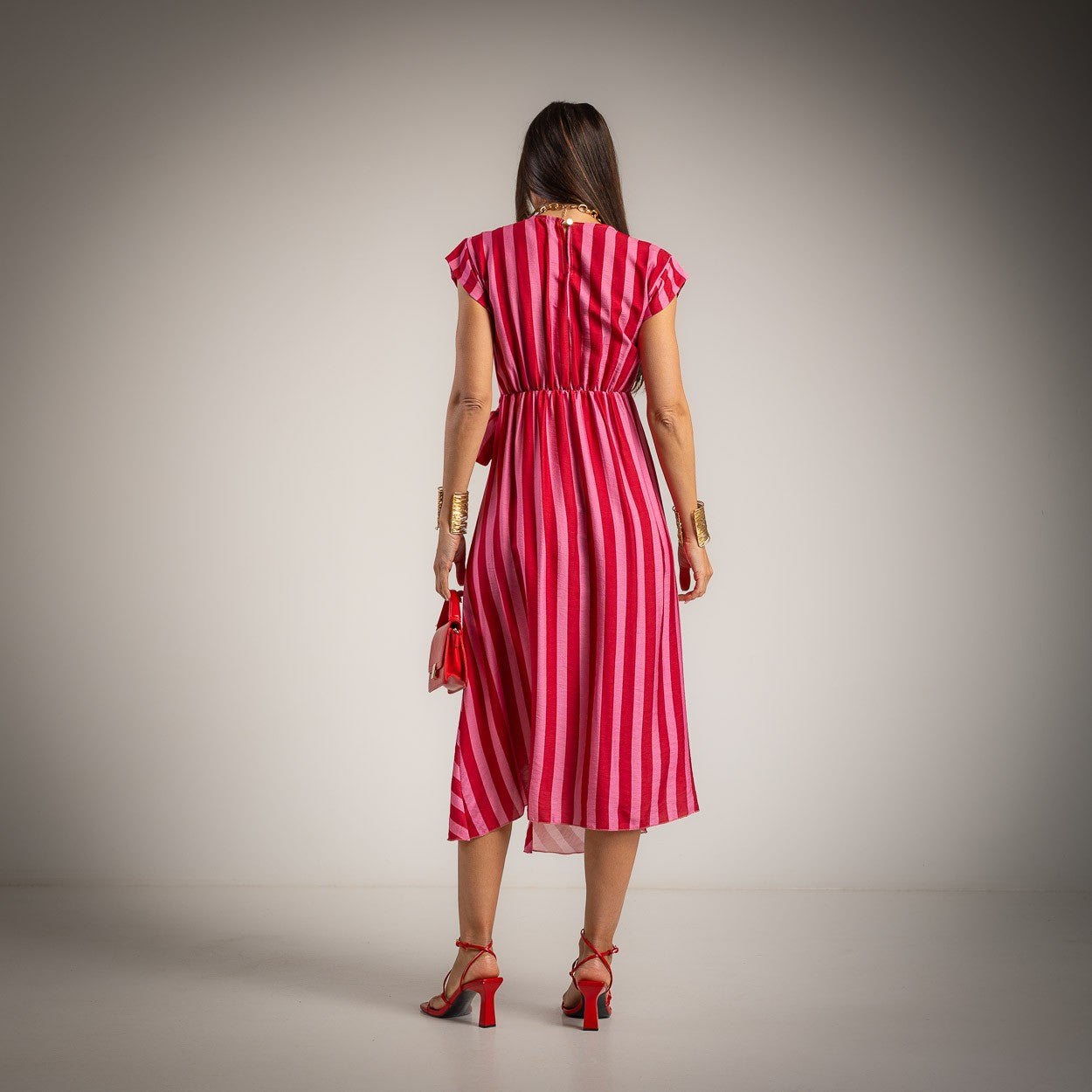 Striped midi dress in bougainvillea pink back view with waist tie