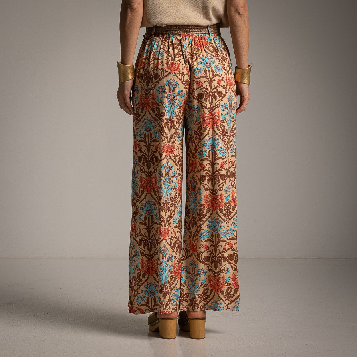 Back view of wide-leg pants with an elegant baroque floral pattern and comfortable elastic waistband.